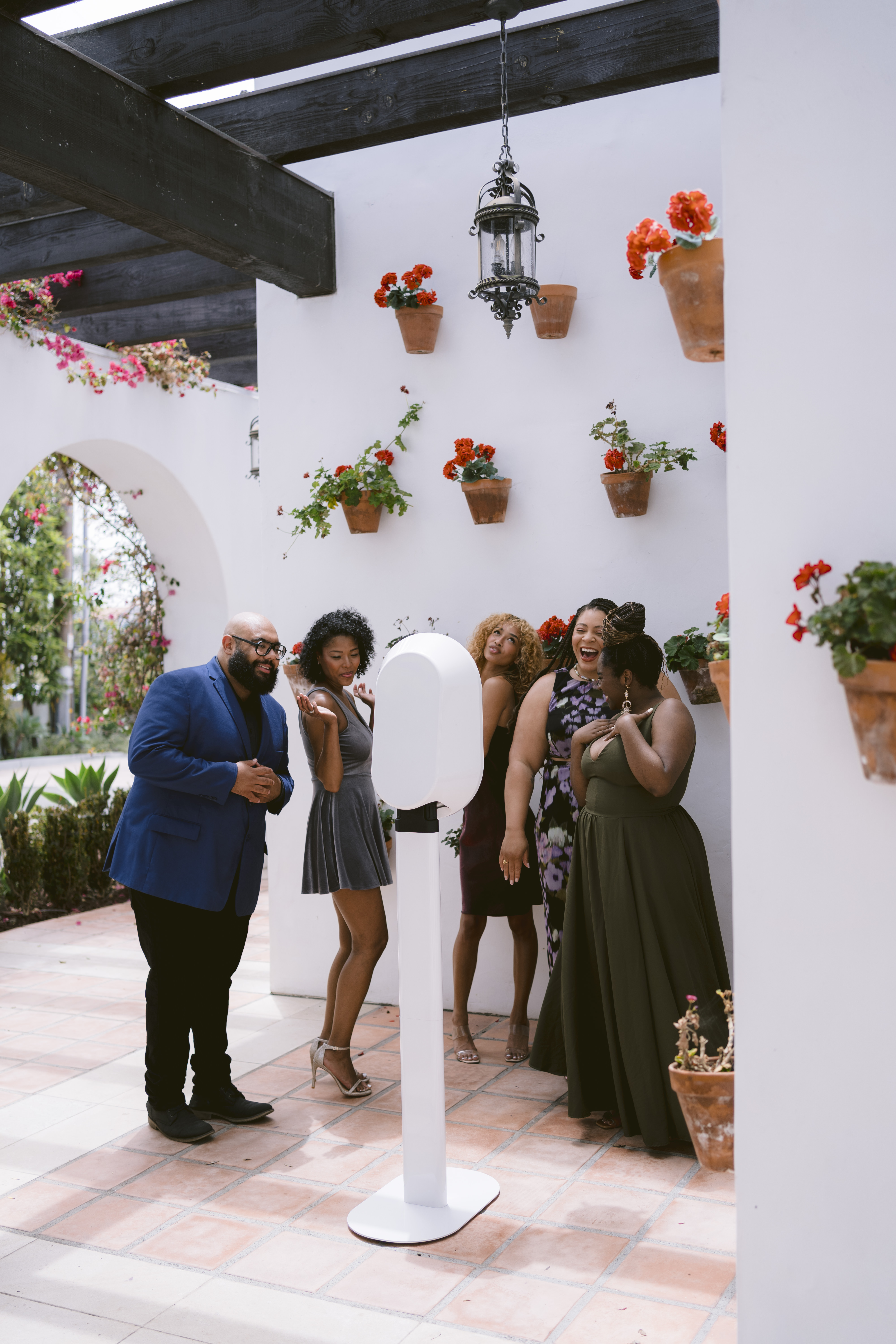 A group of guests gathering around an open-air Salsa 2 photo booth.
