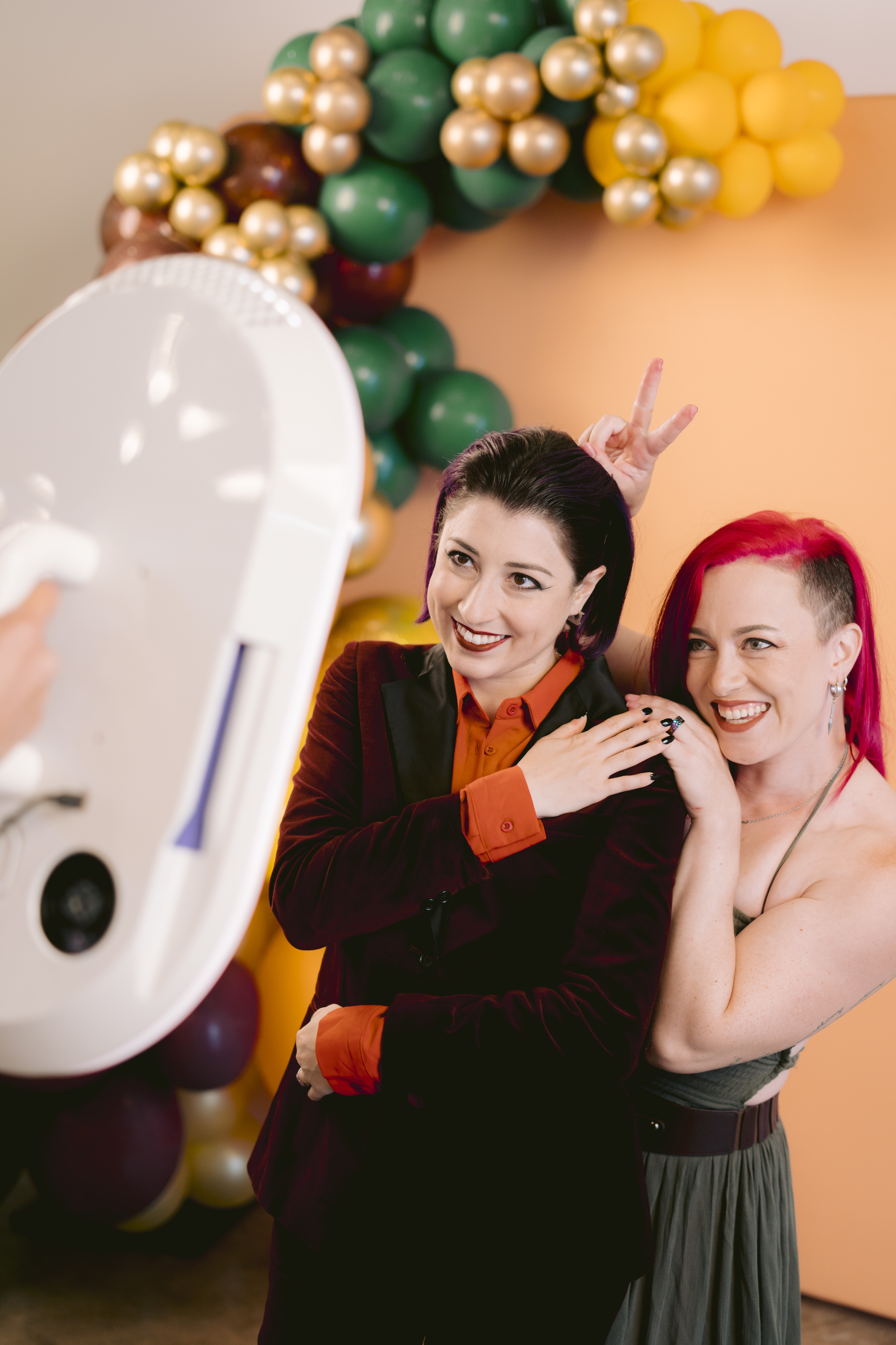 Guests laughing and posing around a Salsa 2 photo booth.
