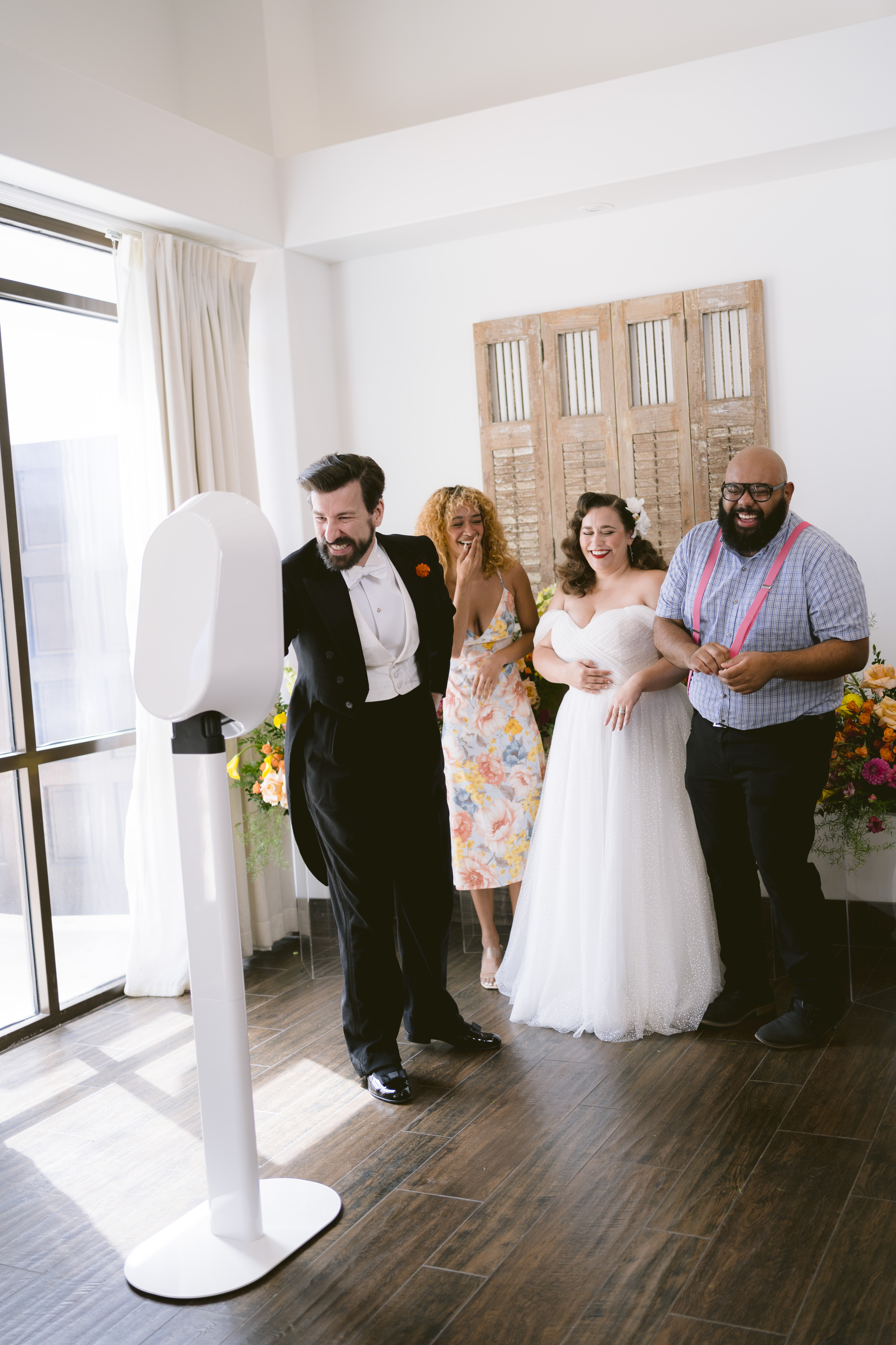 Wedding guests laughing together while using a Salsa 2 photo booth.
