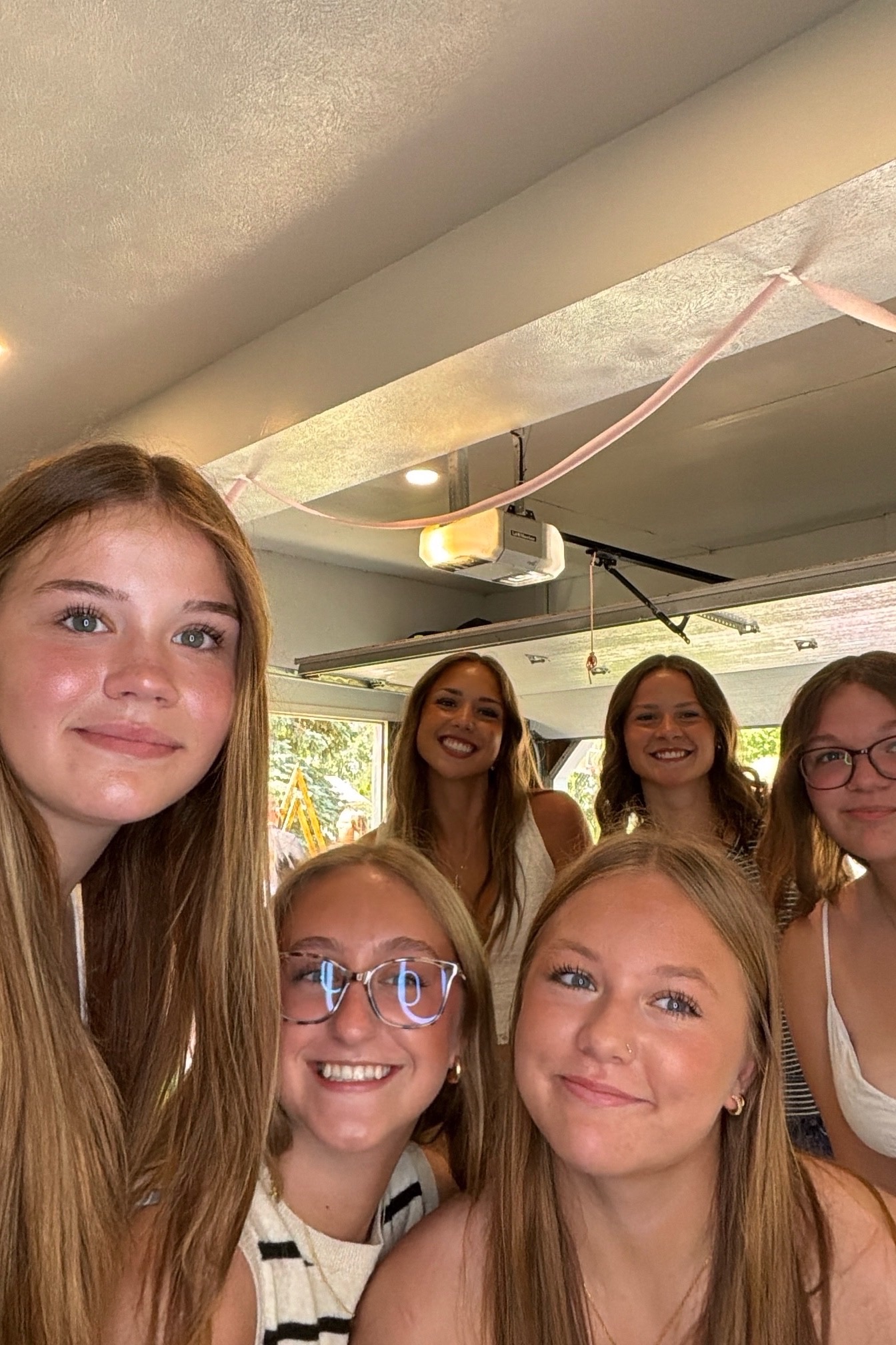 A group of graduation party guests smiling together in a Frank Creations photo booth capture.